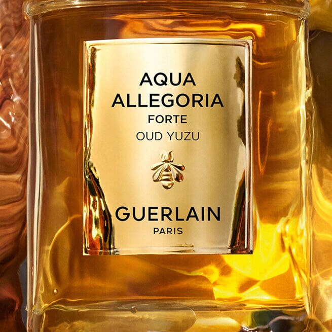Guerlain Aqua Allegoria Forte O/Yuzu Eau de Parfum 75ml bottle, with golden cap and refined decorations, on a light background. - thumbnail 2